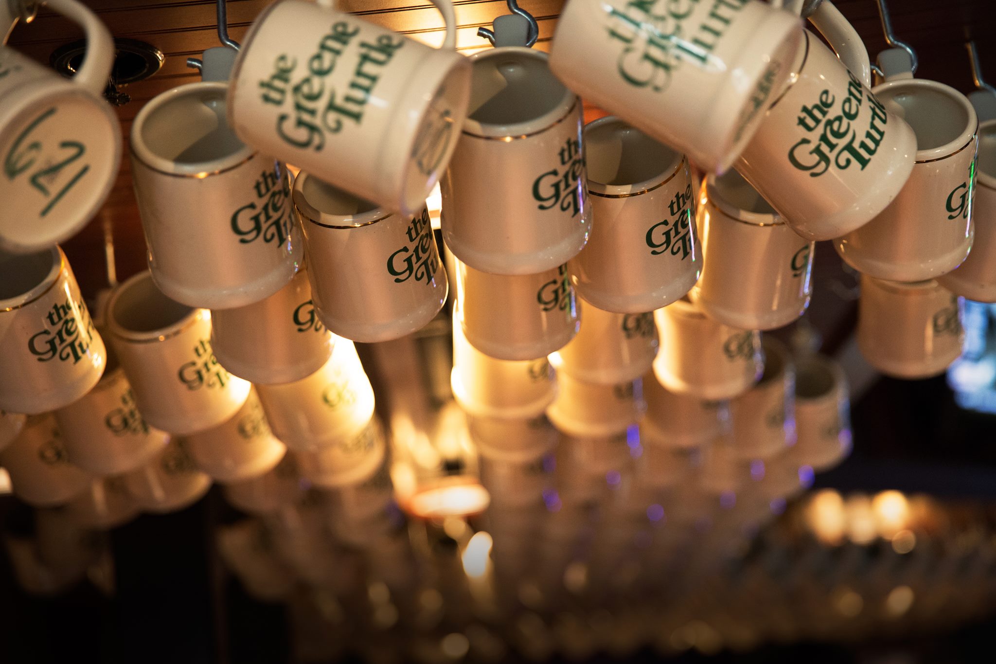 Hanging mugs that read: The Greene Turtle