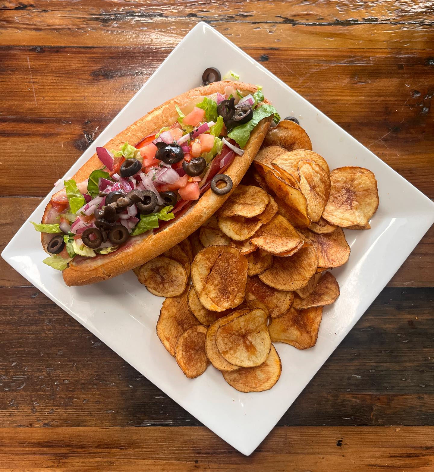 An Italian cold cut with potato chips