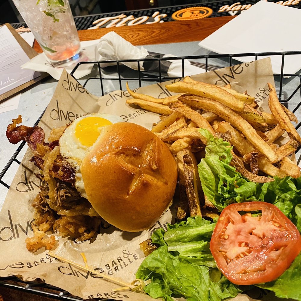 a burger with a fried egg on it and a side of fries