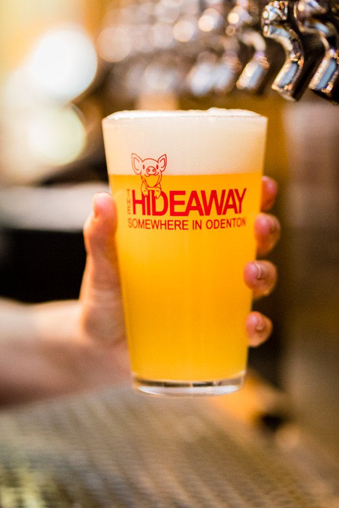a hand holding a glass of beer