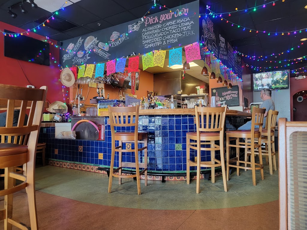 a bar with chairs and lights