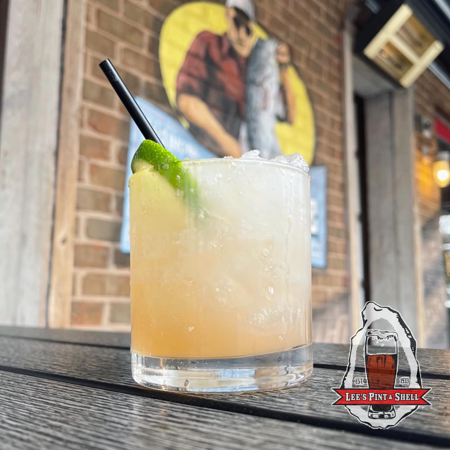 a glass of Spicy Paloma with a lime wedge