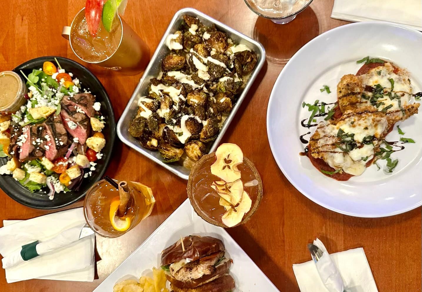 Four plates of food and four cocktails from the fall menu