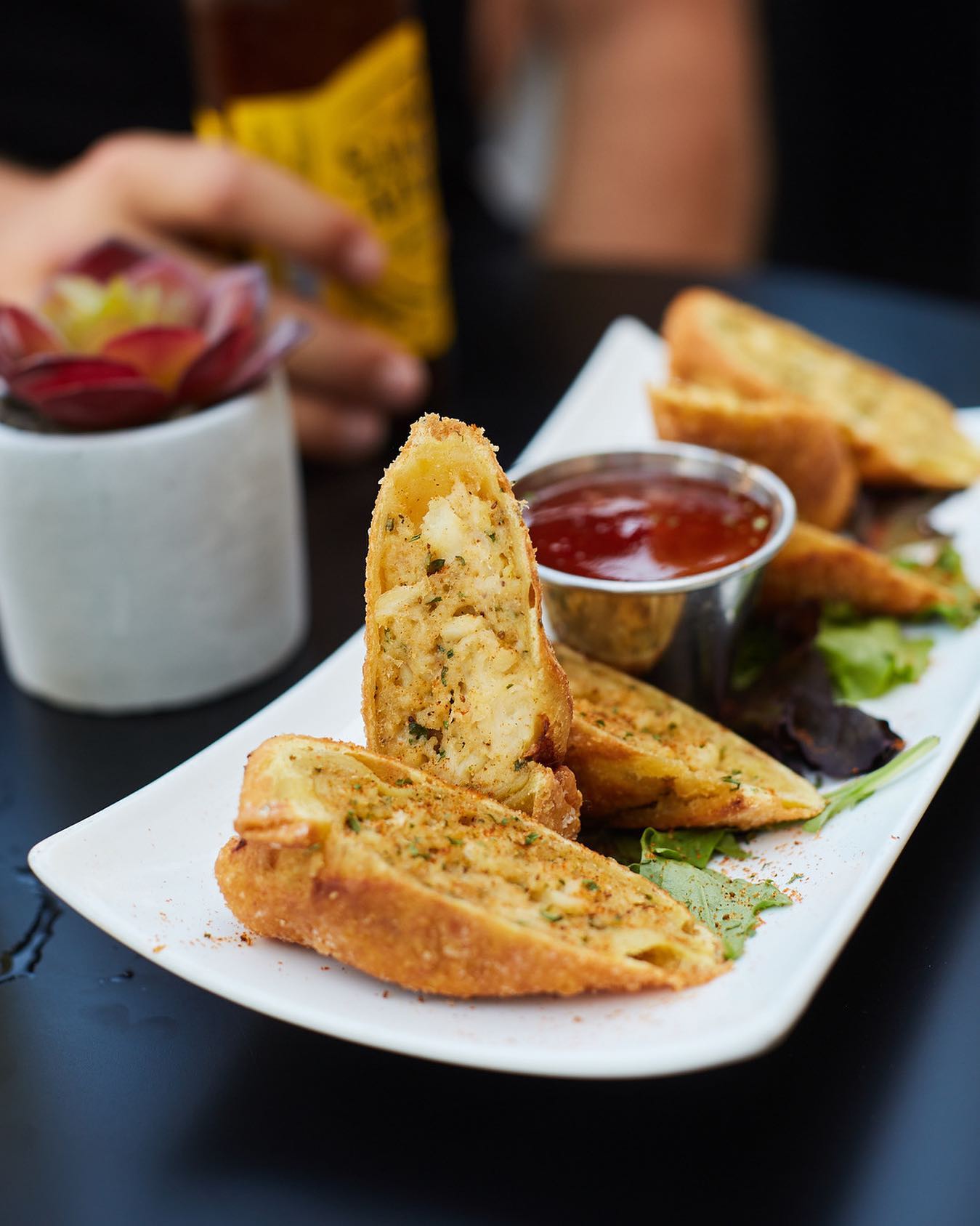 a plate of crab cake egg rolls