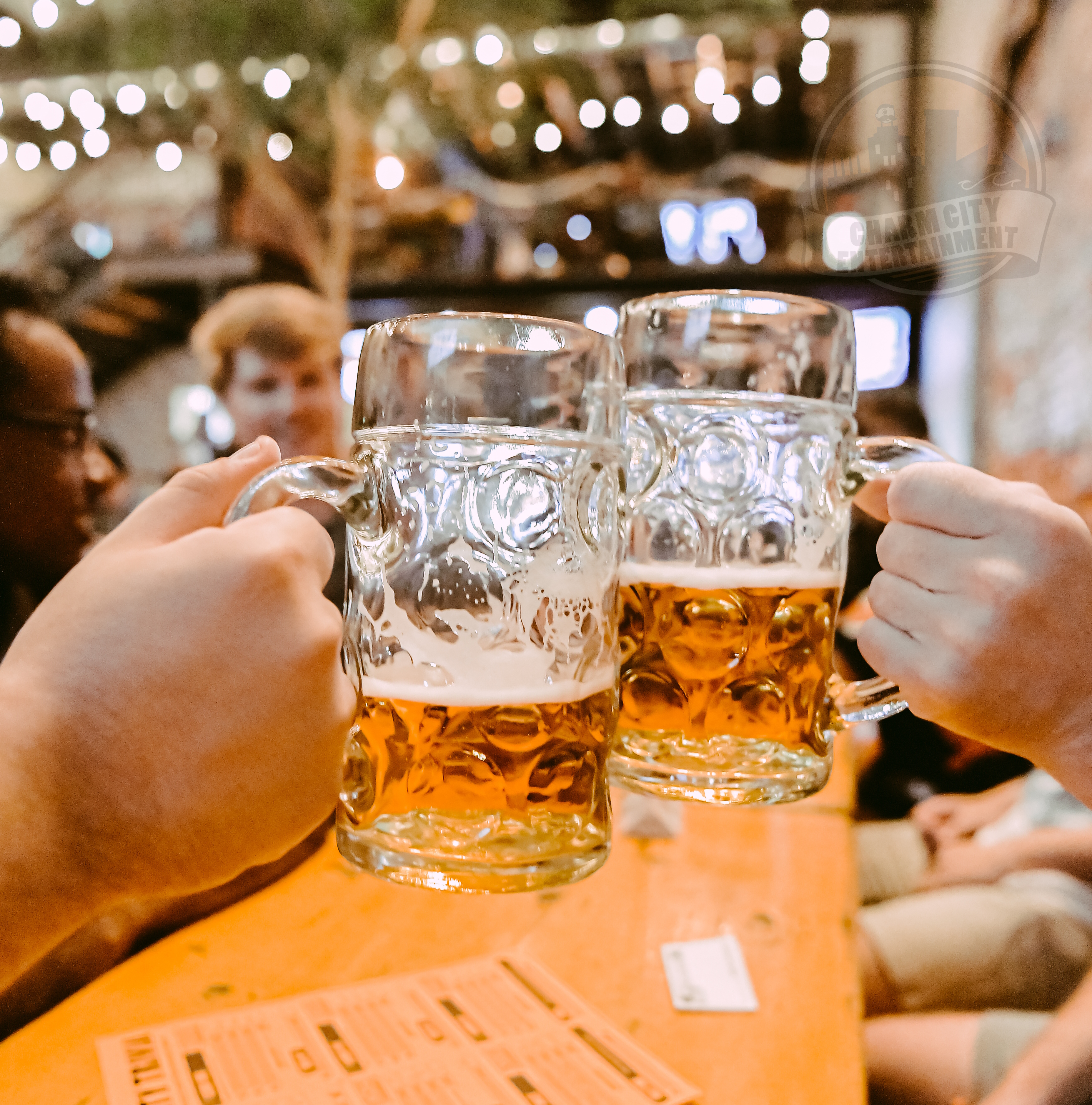 two people cheersing their glasses of beer