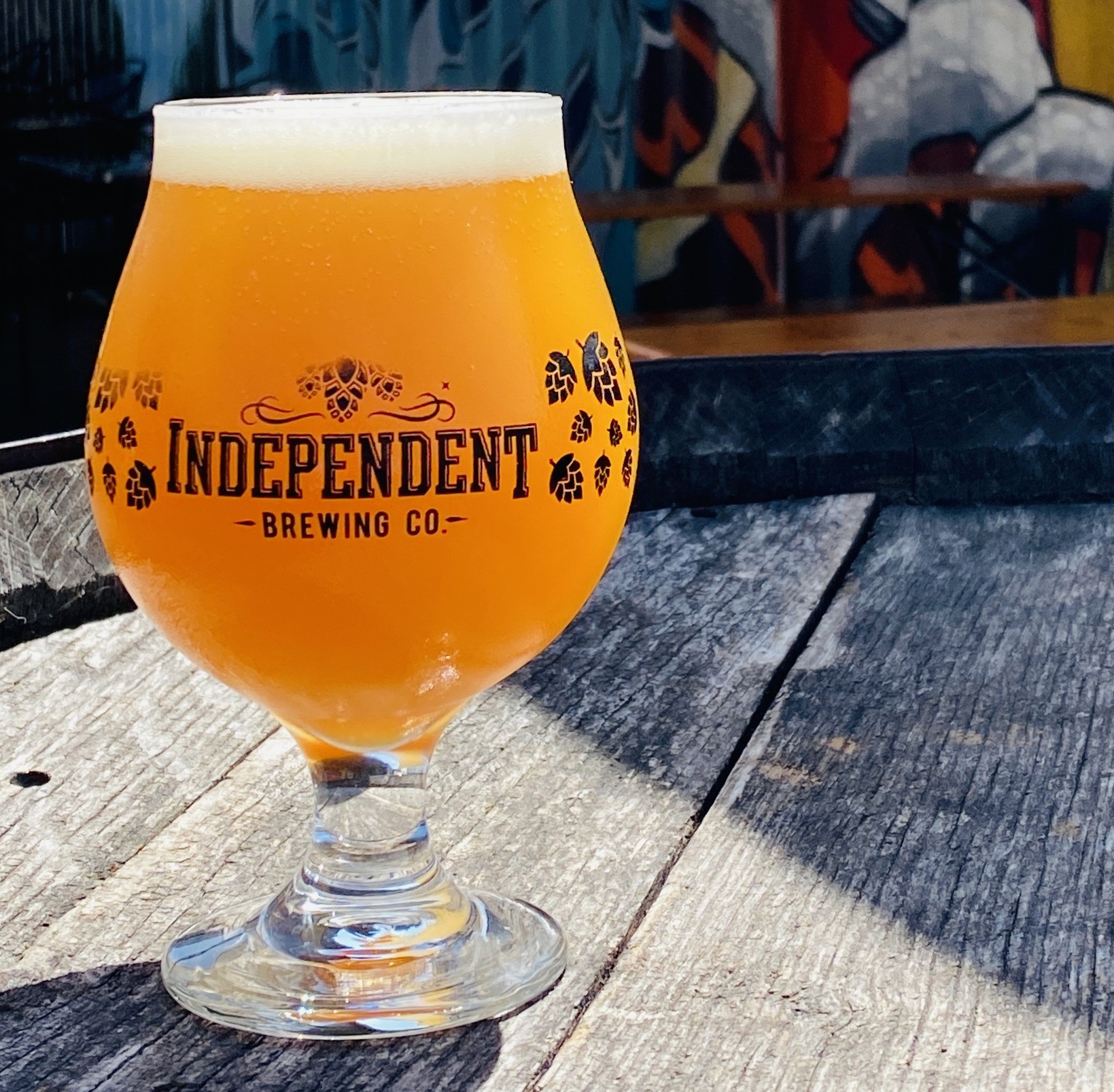 a glass of beer on a table outside