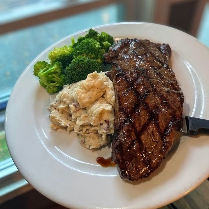an Angus New York Strip Steak with garlic mashed potatoes and broccoli