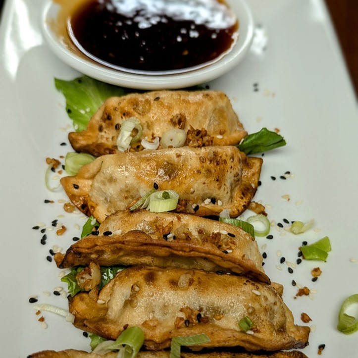 a plate of pot stickers