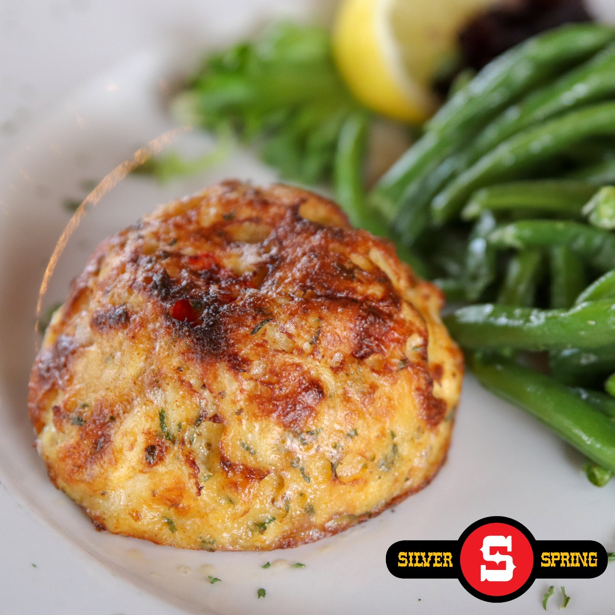 a crabcake with green beans