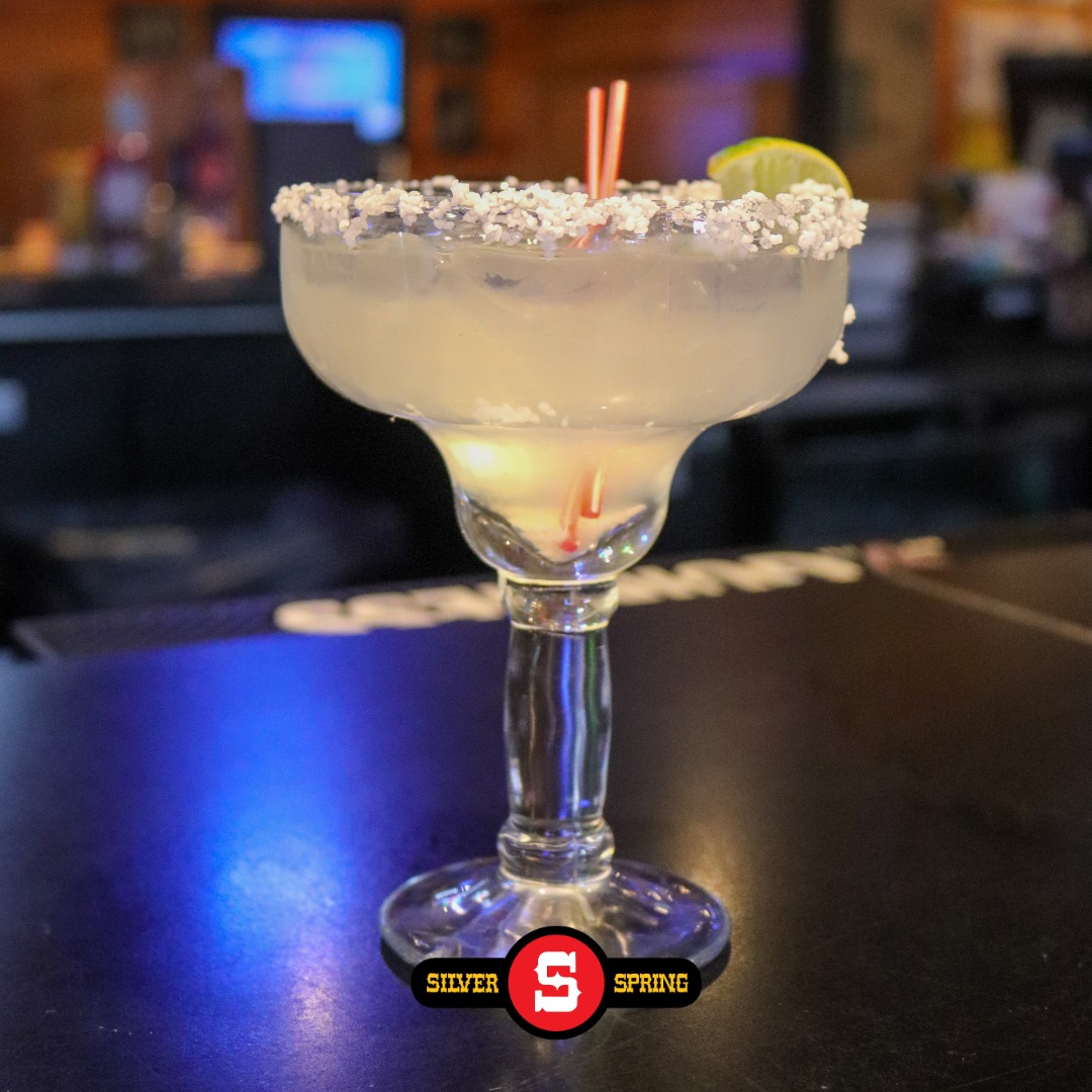a margarita with a salted rim and a lime