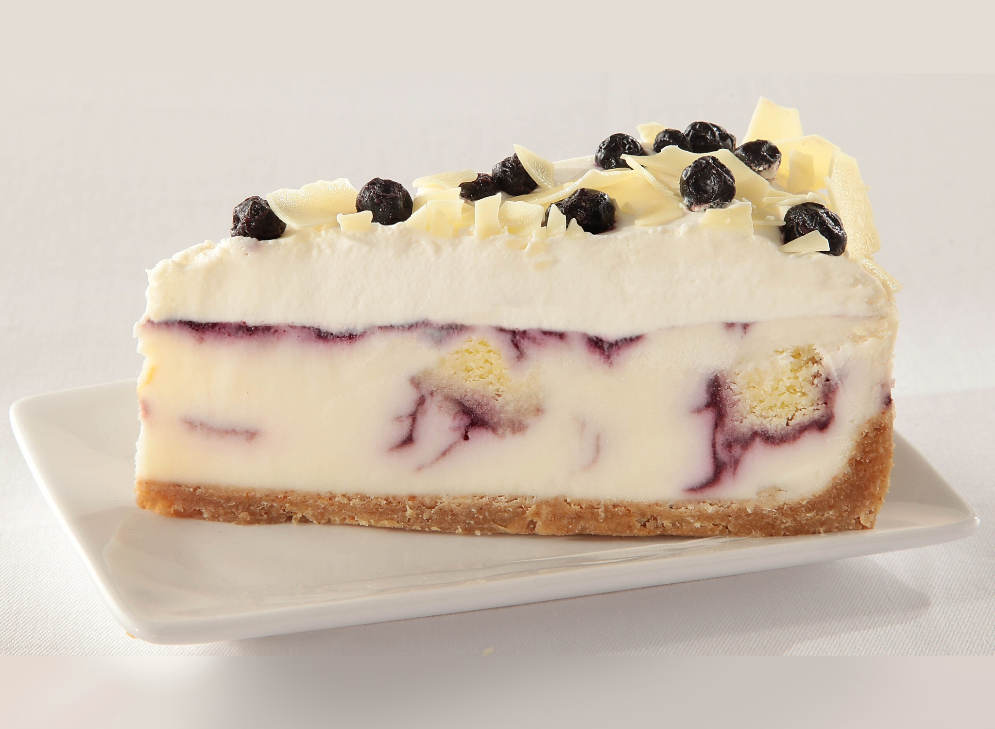 a slice of white chocolate blueberry cheesecake