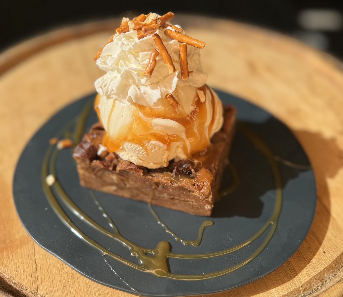 a Salted Caramel Breading Pudding with ice cream and whipped cream