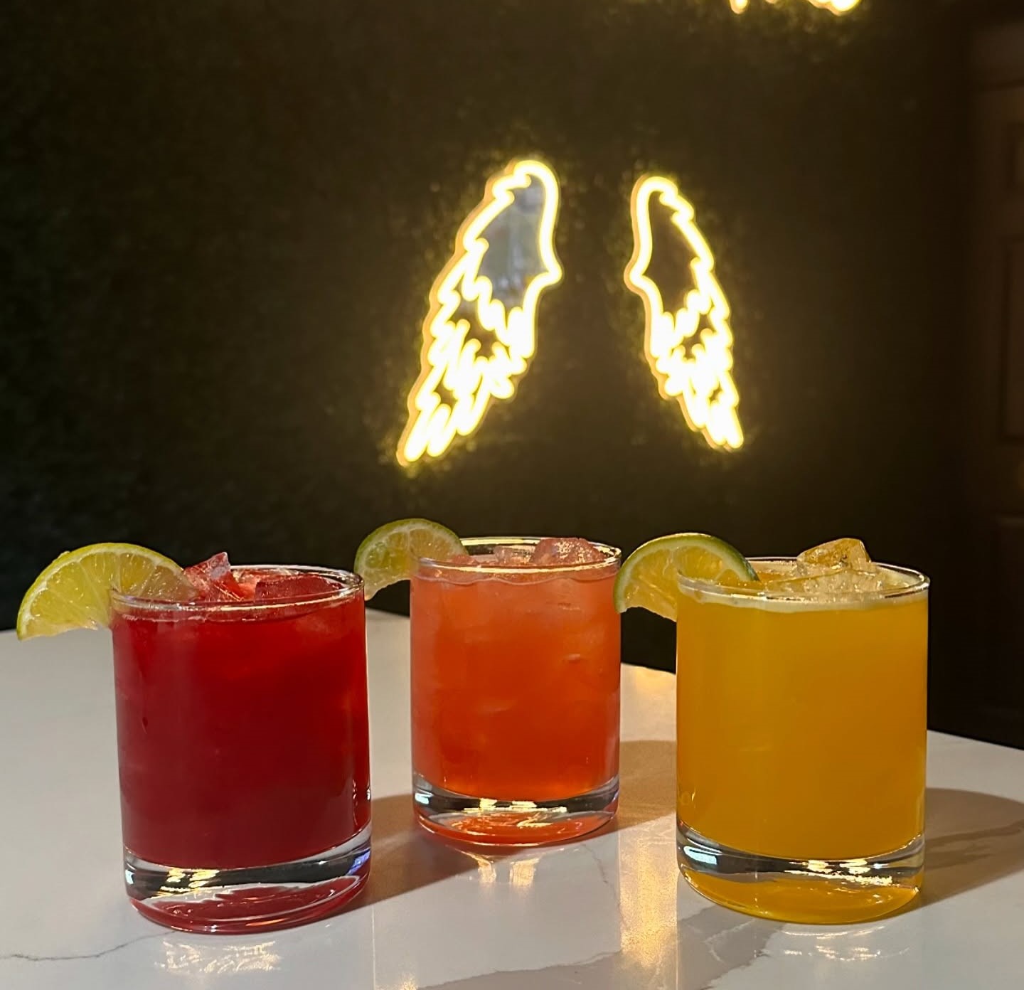 three margaritas in three flavors: strawberry, mango, and watermelon