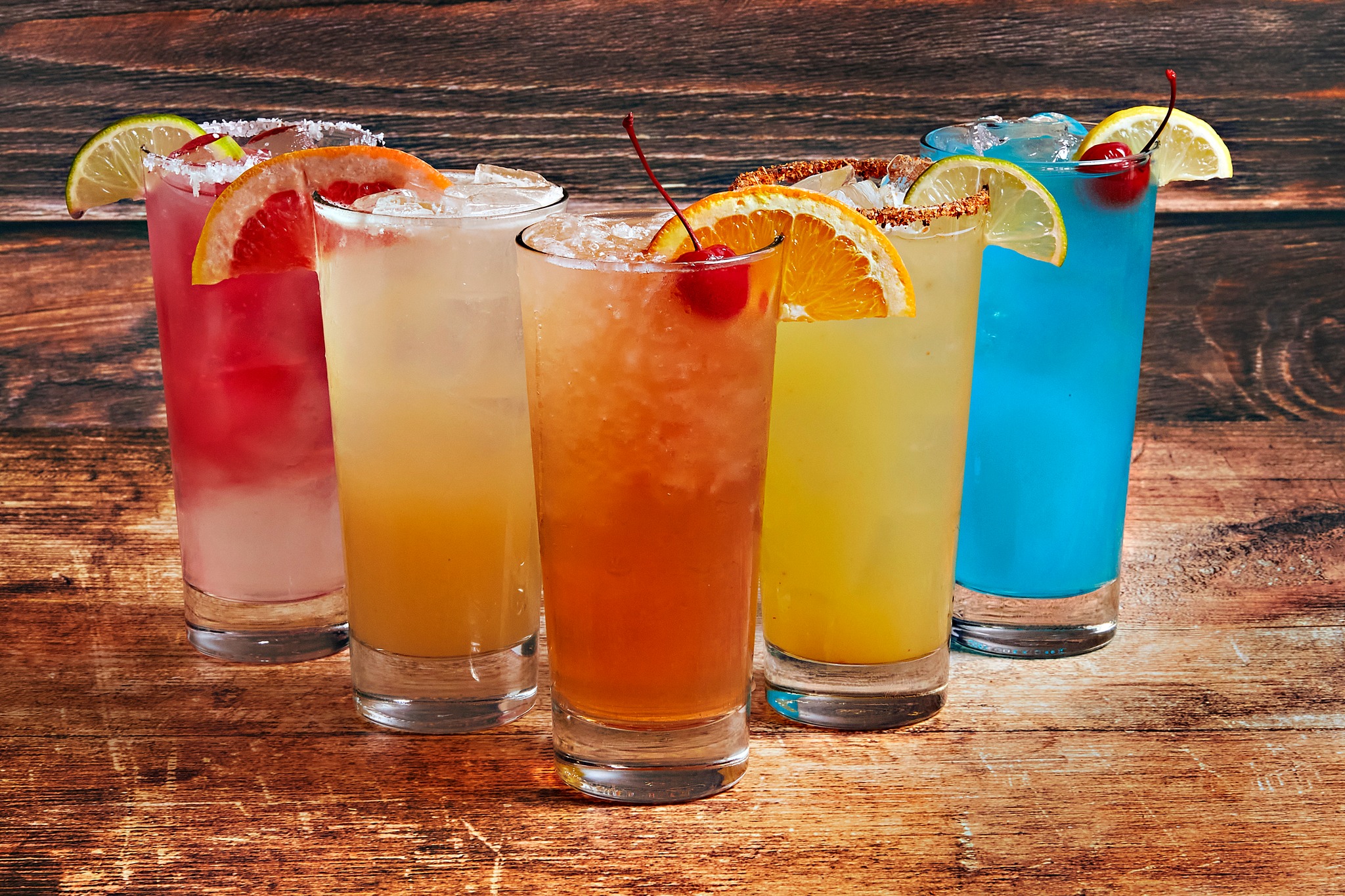 five differently colored cocktails in a row