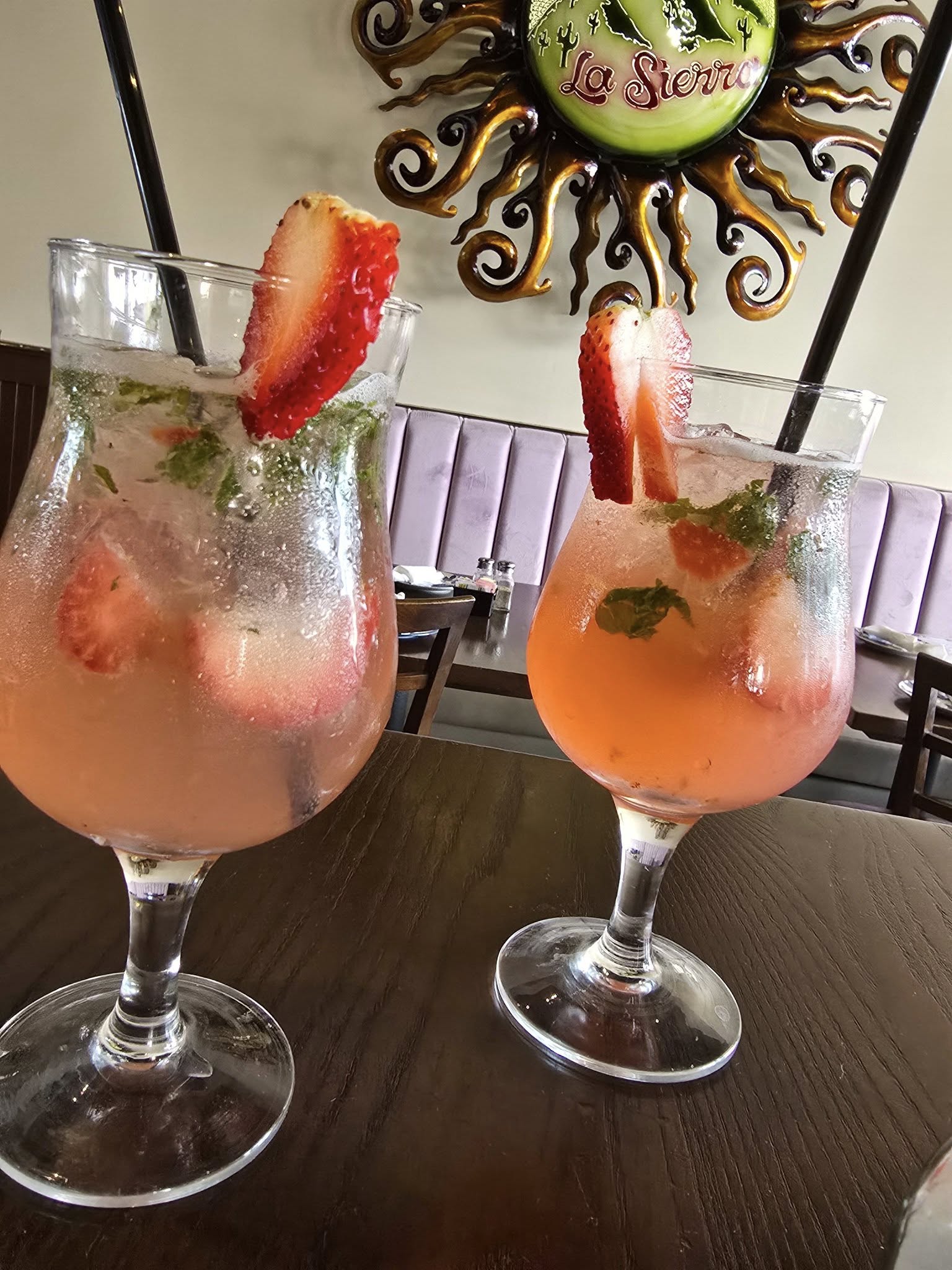 two strawberry and mint mojitos