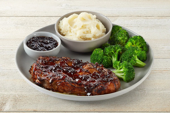 a plate of steak, mashed potatoes, and broccoli