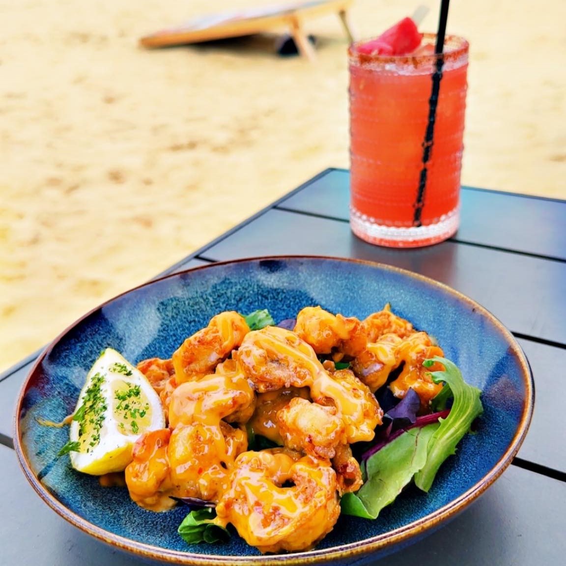 a plate of shrimp with a cocktail