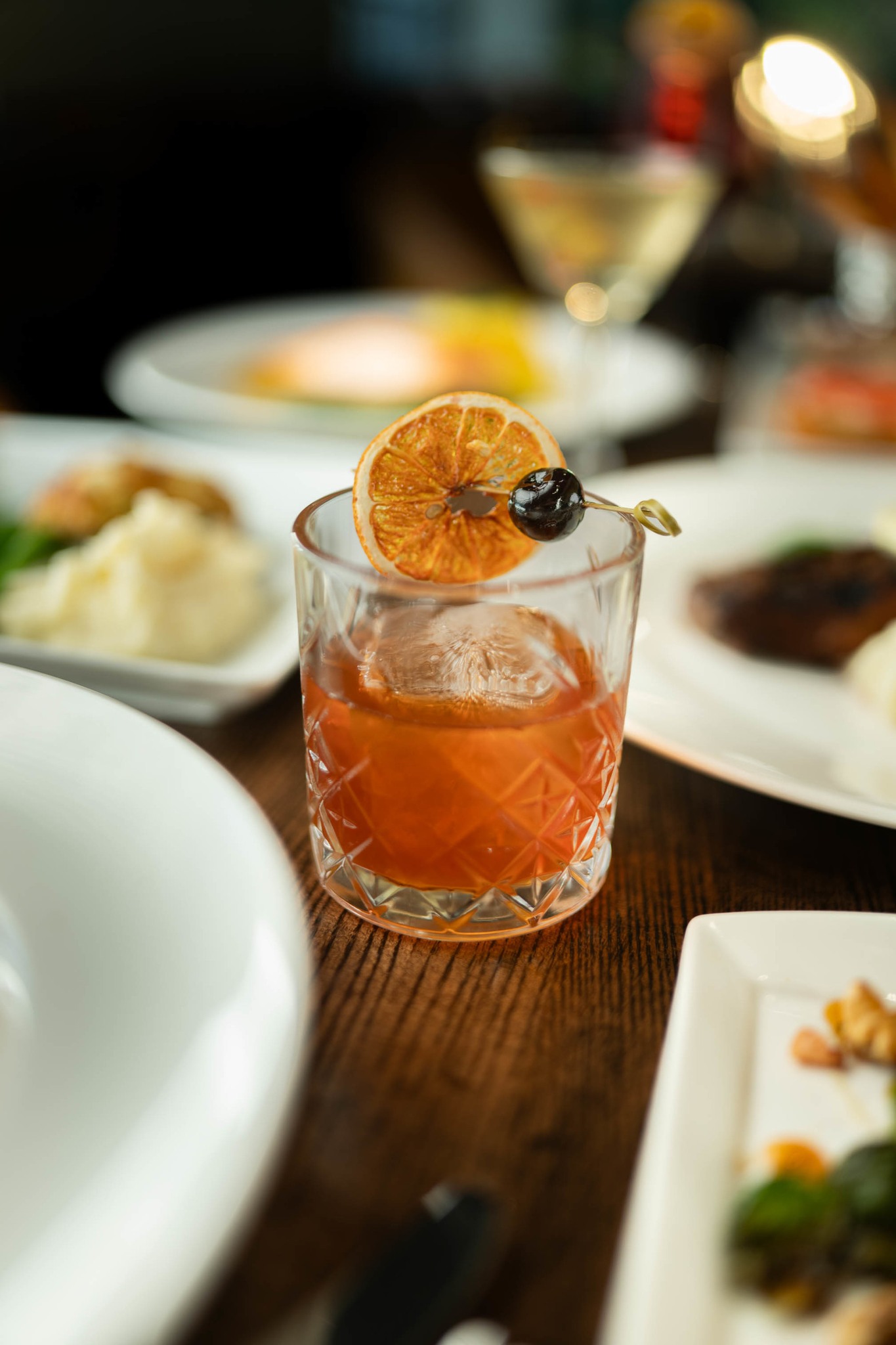 plates of various foods and an orange cocktail