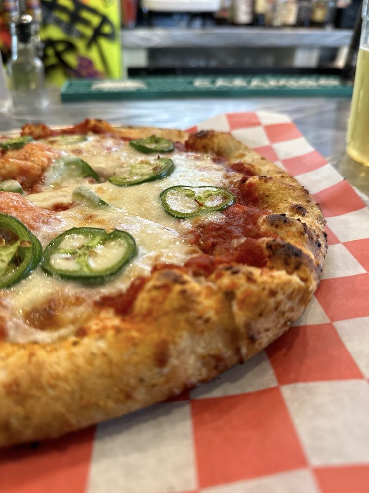 a pizza with jalapenos