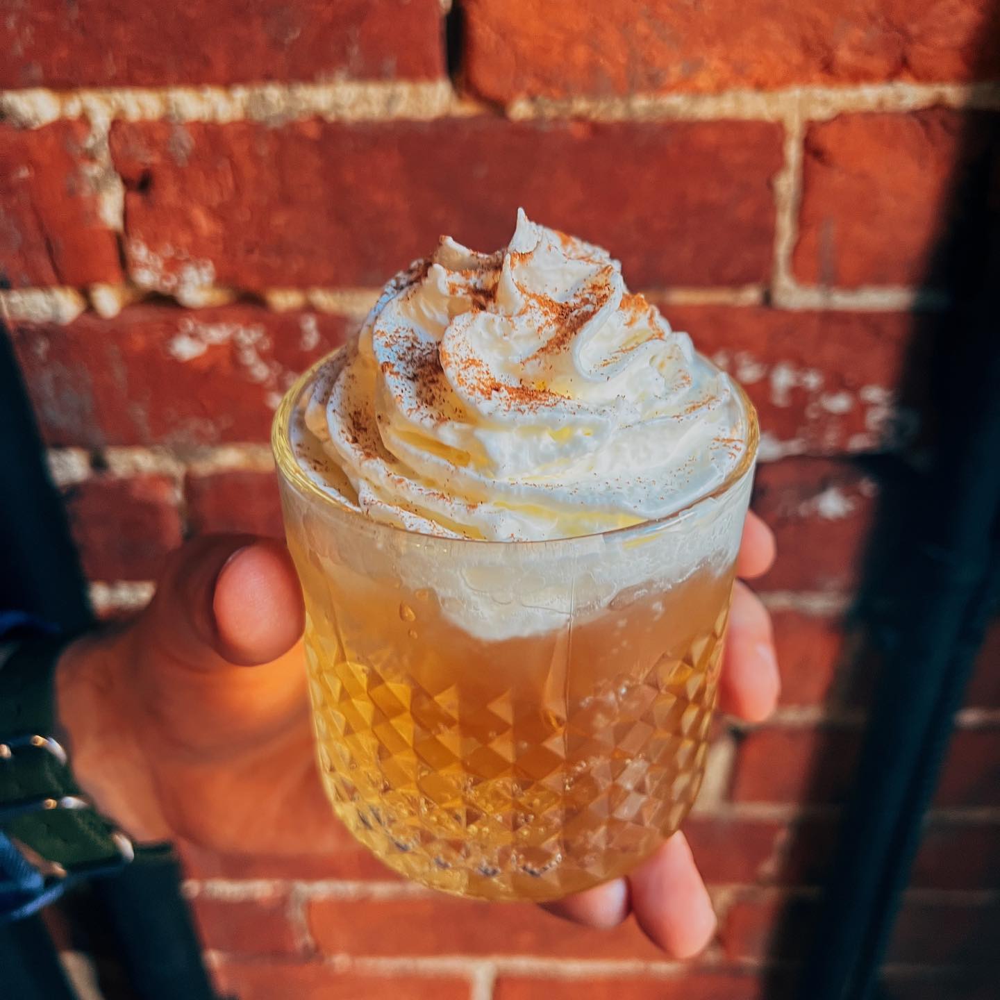 an apple pie cocktail with whipped cream