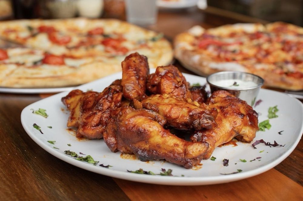 a plate of wings with dip