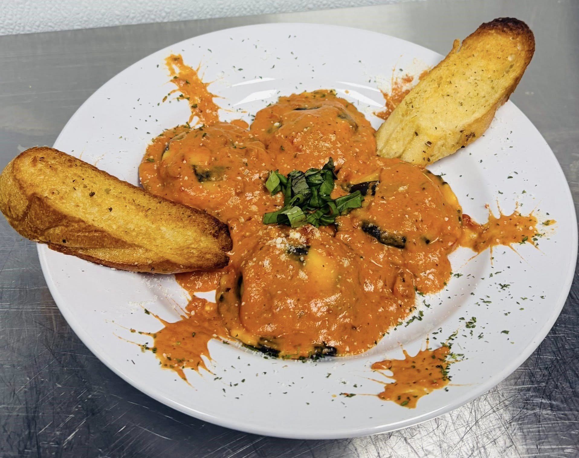 a plate of lobster ravioli with toasted bread