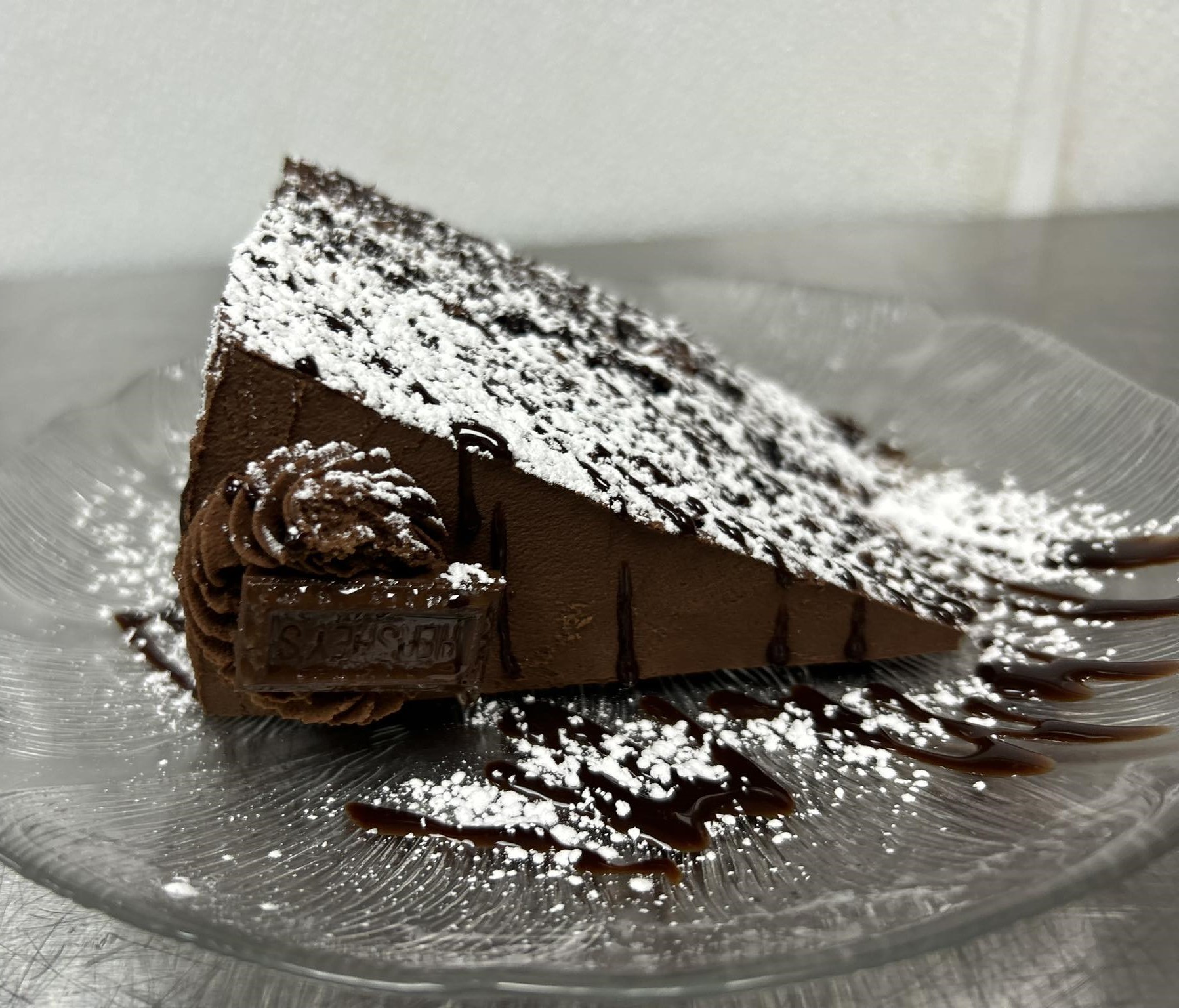 a slice of chocolate cake with powdered sugar