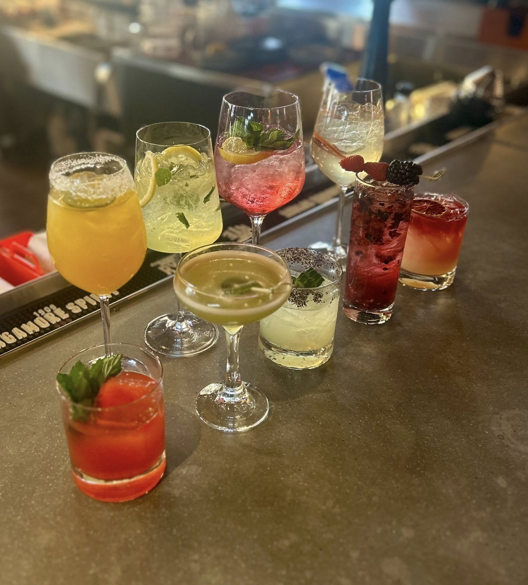 nine different cocktails on a table