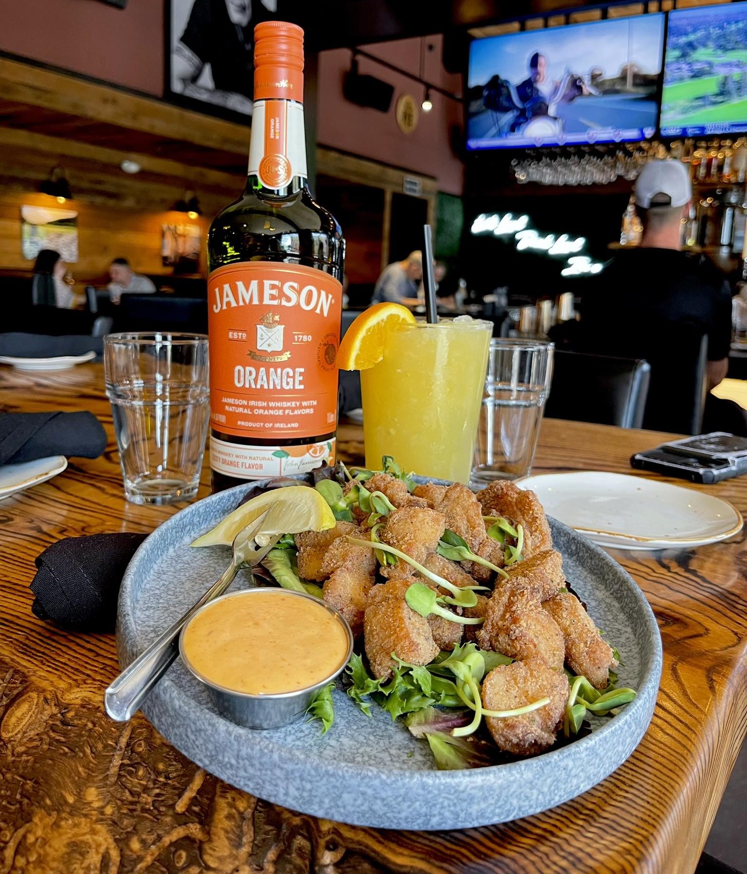 a plate of tilefish bites and an orange crush