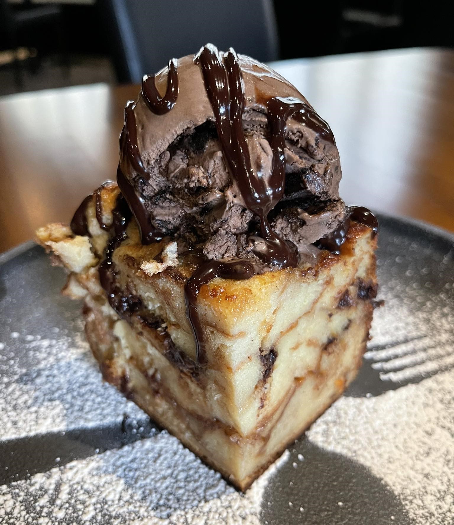 a plate of bread pudding with chocolate ice cream